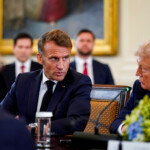 French President Emmanuel Macron speaks to U.S. President Donald Trump during a meeting with Ukrainian President Volodymyr Zelenskiy (not pictured) and European leaders amid negotiations to end the Russian war in Ukraine, at the White House in Washington, D.C., U.S., August 18, 2025. REUTERS/Al Drago