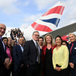 Britain's Prime Minister Keir Starmer poses for a photo with his business delegation before departing London Heathrow Airport as they head to India to meet with Indian Prime Minister Narendra Modi and promote the recently signed trade deal, in London, Britain, October 7, 2025. Leon Neal/Pool via REUTERS
