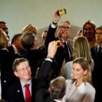 British Prime Minister Keir Starmer takes a selfie with a disposable camera during an interaction with business leaders at the Taj Mahal Palace in Mumbai, India, October 8, 2025. Leon Neal/Pool via REUTERS