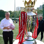 British Prime Minister Keir Starmer views the Premier League trophy as he visits a youth football training centre on October 8, 2025 in Mumbai, India. Leon Neal/Pool via REUTERS