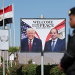 A poster with the U.S. and Egyptian presidents is displayed at Peace Square, ahead of an international summit on Gaza, held amid a ceasefire between Israel and Hamas, at Egypt's Red Sea resort of Sharm el-Sheikh, October 13, 2025. REUTERS/Mohamed Abd El Ghany