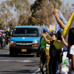 A convoy carrying released hostages, who have been held in Gaza since the deadly October 7, 2023 attack by Hamas, as part of a prisoner-hostage swap and a ceasefire deal between Israel and Hamas, arrive in Reim, southern Israel, October 13, 2025. REUTERS/Amir Cohen