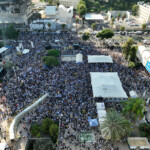 A drone view shows people gathering at "Hostages Square" on the day of the return of Israeli hostages, who have been held in Gaza since the deadly October 7, 2023 attack by Hamas, as part of a prisoner-hostage swap and a ceasefire deal between Israel and Hamas, in Tel Aviv, Israel October 13, 2025. REUTERS/Matanya Tausig