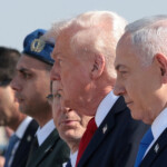 Israeli Prime Minister Benjamin Netanyahu walks with U.S. President Donald Trump and Israeli President Isaac Herzog at Ben Gurion International Airport, amid a U.S.-brokered prisoner-hostage swap and ceasefire deal between Israel and Hamas, in Lod, Israel, October 13, 2025. REUTERS/Evelyn Hockstein