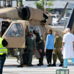 People gather as a helicopter, carrying released hostages who were kidnapped during the deadly October 7, 2023 attack by Hamas and taken to Gaza, arrives at the site of Rabin Medical Center-Beilinson Hospital, amid a hostages-prisoners swap and a ceasefire deal between Israel and Hamas in Gaza, in Petah Tikva, Israel October 13, 2025. REUTERS/Stoyan Nenov