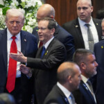 U.S. President Donald Trump enters the Knesset, with Israel's President Isaac Herzog and Israel's Prime Minister Benjamin Netanyahu, before he speaks, Monday, Oct. 13, 2025, in Jerusalem. Evan Vucci/Pool via REUTERS
