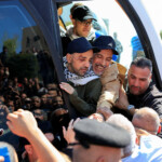 Freed Palestinian prisoners react in a bus after being released from an Israeli jail as part of a hostages-prisoners swap and a ceasefire deal in Gaza between Hamas and Israel, in Ramallah, in the Israeli-occupied West Bank, October 13, 2025. REUTERS/Mussa Qawasma TPX IMAGES OF THE DAY