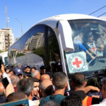 Palestinian security forces stand guard as families wait for freed Palestinian prisoners in a bus after being released from an Israeli jail as part of a hostages-prisoners swap and a ceasefire deal in Gaza between Hamas and Israel, in Ramallah, in the Israeli-occupied West Bank, October 13, 2025. REUTERS/Mussa Qawasma