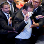 JERUSALEM - OCTOBER 13: Knesset member Ayman Odeh is removed from the hall after raising a sign while U.S. President Donald Trump addresses the Knesset, Israel’s parliament, on October 13, 2025 in Jerusalem. Chip Somodevilla/Pool via REUTERS