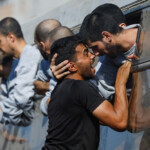 A man greets a freed Palestinian prisoner released by Israel as part of a hostages-prisoners swap and a ceasefire deal between Hamas and Israel, in Khan Younis in the southern Gaza Strip, October 13, 2025. REUTERS/Mahmoud Issa