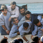 Freed Palestinian prisoners look out of a bus after they were released by Israel as part of a hostages-prisoners swap and a ceasefire deal between Hamas and Israel, in Khan Younis in the southern Gaza Strip, October 13, 2025. REUTERS/Mahmoud Issa TPX IMAGES OF THE DAY