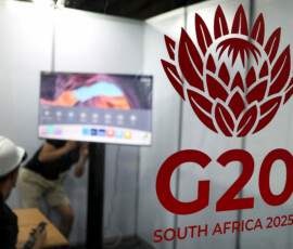 Workers appear behind a G20 logo as South Africa prepares to host the G20 Summit in Johannesburg from November 22 to 23, in Johannesburg, South Africa, November 13, 2025. REUTERS/Siphiwe Sibeko