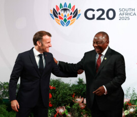 France's President Emmanuel Macron is greeted by South Africa's President Cyril Ramaphosa, as he arrives on the first day of the G20 Summit at the Nasrec Expo Centre in Johannesburg, South Africa, November 22, 2025. REUTERS/Yves Herman