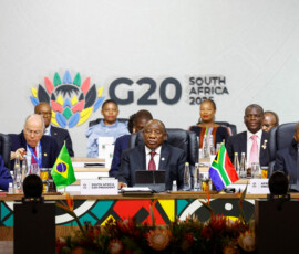 South African President Cyril Ramaphosa speaks alongside Brazil's President Luiz Inacio Lula da Silva and Chairperson of the African Union Joao Lourenco at a plenary session on the opening day of the G20 Summit at the Nasrec Expo Centre in Johannesburg, South Africa, November 22, 2025. REUTERS/Thomas Mukoya/Pool