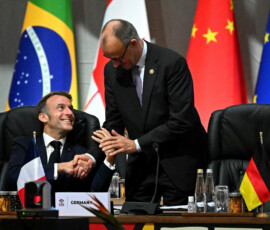 France's President Emmanuel Macron reacts as he speaks with German Chancellor Friedrich Merz during the opening plenary session at the G20 Summit on November 22, 2025 in Johannesburg, South Africa ahead of the G20 Summit. Leon Neal/Pool via REUTERS