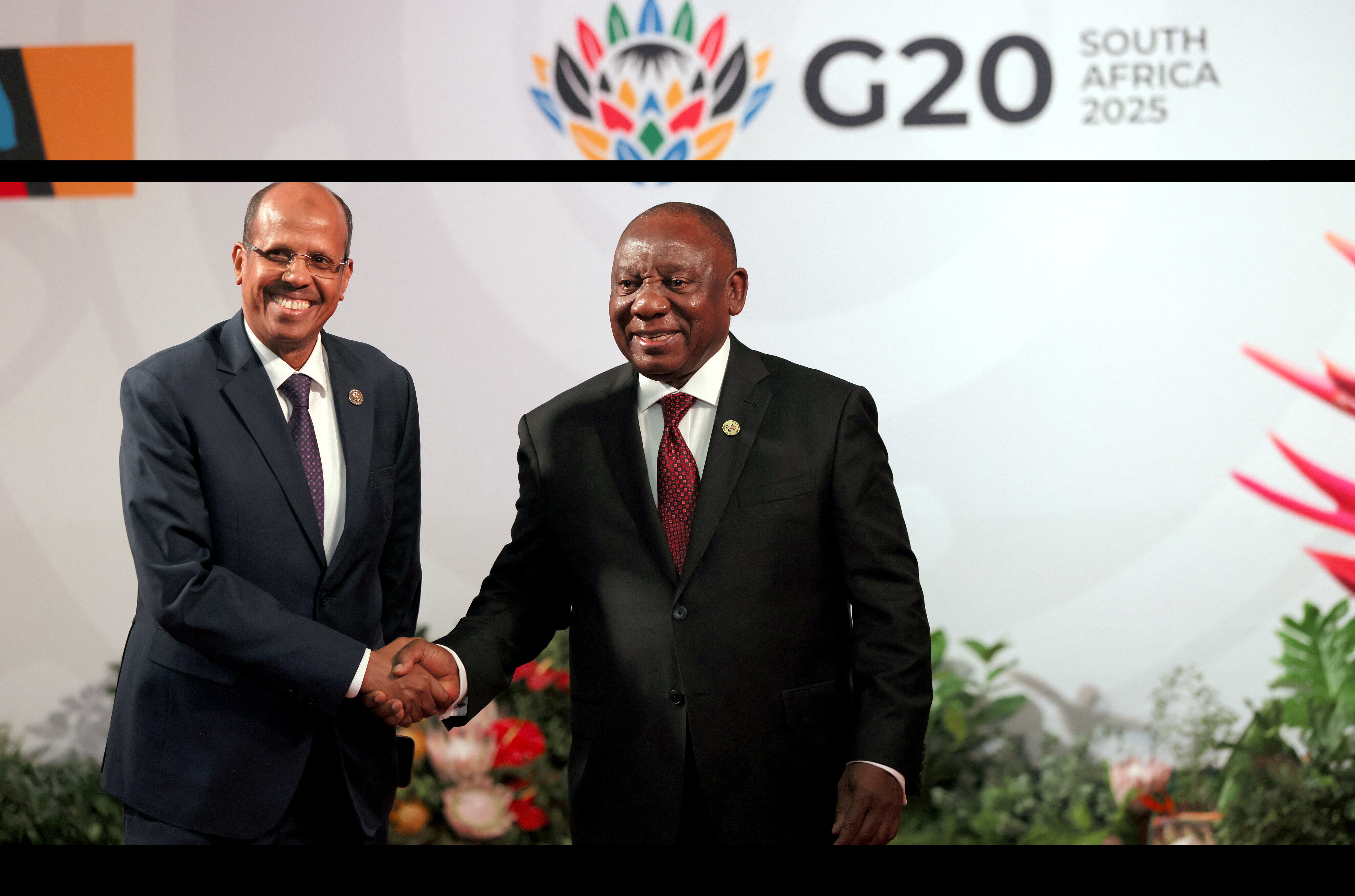 South African President Cyril Ramaphosa welcomes African Union Commission Chairperson, Mahmoud Ali Youssouf at the Johannesburg Expo Centre for the G20 Leaders' Summit, Johannesburg, South Africa, 22 November 2025, for the Group of Twenty (G20) Leaders' Summit. Halden Krog/Pool via REUTERS
