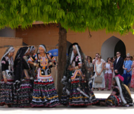 Dancers and members of United States Secretary of State Marco Rubio’s team wait in the shade during Rubio’s tour of Amber Fort in Jaipur, India, Monday, May 25, 2026. Julia Demaree Nikhinson/Pool via REUTERS