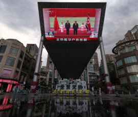 A giant screen at a shopping area shows news footage of Chinese President Xi Jinping and North Korean leader Kim Jong Un attending a welcoming ceremony in North Korea, in Beijing, China, June 8, 2026. REUTERS/Tingshu Wang