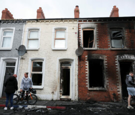 People inspect the damage in their neighbourhood, in the aftermath of anti-immigrant protests following a knife attack on June 8, which left a man seriously injured and prompted police to declare a critical incident, at Lendrick Street, east Belfast, Northern Ireland, June 10, 2026. REUTERS/Isabel Infantes