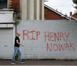 A man walks past a message written on a wall for student Henry Nowak, the victim of a knife attack in the southern England city of Southampton last December, in east Belfast, Northern Ireland, June 10, 2026. REUTERS/Isabel Infantes