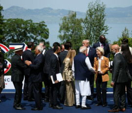 U.S. President Donald Trump, French President Emmanuel Macron, Canadian Prime Minister Mark Carney, Italian Prime Minister Giorgia Meloni, Japanese Prime Minister Sanae Takaichi, European Commission President Ursula von der Leyen, European Council President Antonio Costa, Egyptian President Abdel Fattah al-Sisi, South Korea's President Lee Jae Myung, India's Prime Minister Narendra Modi, Brazilian President Luiz Inacio Lula da Silva, Kenya's President William Ruto and British Prime Minister Keir Starmer mingle as they wait for a family photo during the G7 summit, in Evian-les-Bains, France, June 16, 2026. REUTERS/Isabel Infantes/Pool