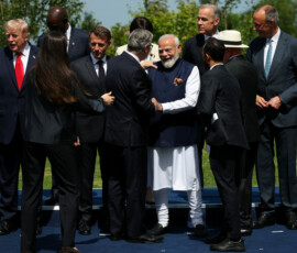 British Prime Minister Keir Starmer speaks with India's Prime Minister Narendra Modi, as they wait with other leaders for a family photo during the G7 summit, in Evian-les-Bains, France, June 16, 2026. REUTERS/Isabel Infantes/Pool