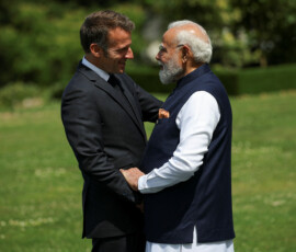 French President Emmanuel Macron and Indian Prime Minister Narendra Modi greet each other ahead of a family photo, on the sidelines of the G7 summit, in Evian-les-Bains, France, June 16, 2026. REUTERS/Isabel Infantes/Pool