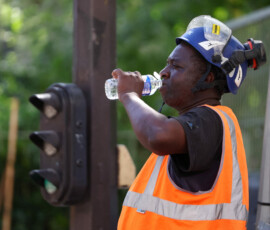 A worker drink water on a construction site in Paris as temperatures rise during a heatwave affecting a large part of France, June 22, 2026. REUTERS/Abdul Saboor