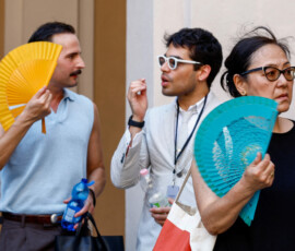People fan themselves during Thom Browne’s Spring/Summer 2027 men’s collection show as part of Milan Fashion Week, in Milan, Italy, June 22, 2026. REUTERS/Alessandro Garofalo