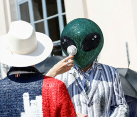 A person wearing an alien mask sits among the audience with a portable electric fan during Thom Browne’s Spring/Summer 2027 men’s collection show as part of Milan Fashion Week, in Milan, Italy, June 22, 2026. REUTERS/Alessandro Garofalo TPX IMAGES OF THE DAY