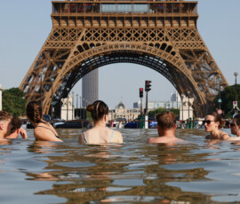People cool off in the Trocadero Fountain next to the Eiffel Tower as temperatures rise during a heatwave affecting a large part of the country, in Paris, France, June 22, 2026. REUTERS/Abdul Saboor