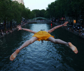 A man dives into the water in the Canal Saint-Martin as temperatures rise during a heatwave affecting a large part of the country, in Paris, France, June 22, 2026. REUTERS/Abdul Saboor TPX IMAGES OF THE DAY