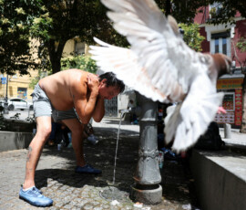 A man pours water over himself to cool off during a hot day amid a heatwave in Madrid, Spain, June 23, 2026. REUTERS/Mohammed Salem