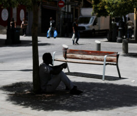 A man sits in the shade of a tree to escape the heat during a heatwave in Madrid, Spain, June 23, 2026. REUTERS/Mohammed Salem