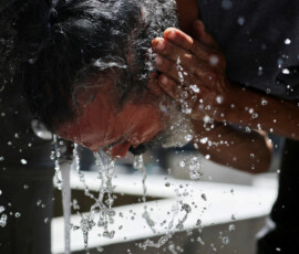 A man washes his face to cool off during a hot day amid a heatwave in Madrid, Spain, June 23, 2026. REUTERS/Mohammed Salem TPX IMAGES OF THE DAY