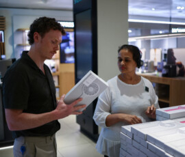A customer buys a handheld fan on John Lewis Oxford Street, as Britain experiences record temperatures disrupting schools and transport networks, in London, Britain, June 23, 2026. REUTERS/Guglielmo Mangiapane