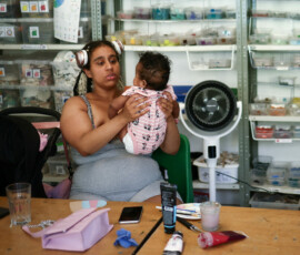 A woman holds her baby as she sits near a fan at Art4Space, a community arts centre where people can escape the heat as Britain endures record temperatures that have disrupted schools and transport networks, in London, Britain, June 24, 2026. REUTERS/Guglielmo Mangiapane
TPX IMAGES OF THE DAY