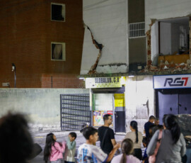 People gather outdoors near a damaged building after an earthquake, in Caracas, Venezuela, June 24, 2026. REUTERS/Fausto Torrealba