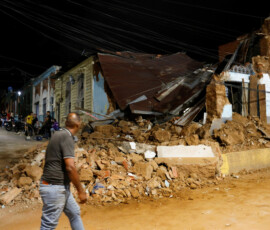 A person walks past a damaged building after an earthquake, in Caracas, Venezuela, June 24, 2026. REUTERS/Fausto Torrealba