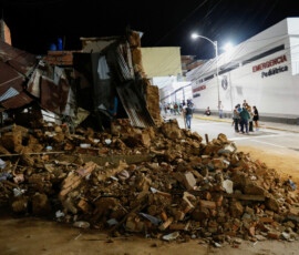 People stand outside a hospital next to a damaged building after an earthquake, in Caracas, Venezuela, June 24, 2026. REUTERS/Fausto Torrealba