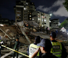 Police officers and rescuers work at the site of damaged buildings in the aftermath of an earthquake, in Caracas, Venezuela, June 24, 2026. REUTERS/Fausto Torrealba