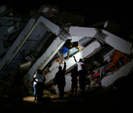 A person walks amid rubble of a destroyed building after an earthquake, in La Guaira, Venezuela, June 25, 2026. REUTERS/Maxwell Briceno