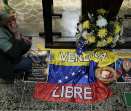 Venezuela-related items sit next to flowers during a Mass to pray for those affected by earthquakes in Venezuela and for the Venezuelan people, in Bogota, Colombia, June 25, 2026. REUTERS/Nathalia Angarita