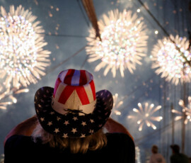 A person wearing a hat in the colors of the U.S. flag watches Macy's Fourth of July fireworks as the United States celebrates its 250th anniversary on Independence Day, from a ship at Brooklyn Bridge Marina, in New York City, U.S., July 4, 2026. REUTERS/Heather Khalifa TPX IMAGES OF THE DAY