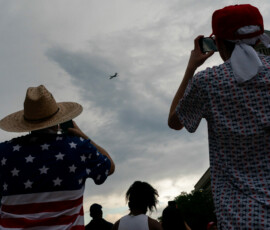 People watch an aircraft fly over the National Mall during Salute to America, marking the 250th anniversary of U.S. Independence in Washington, D.C., U.S., July 4, 2026. REUTERS/Elizabeth Frantz