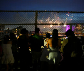 People watch fireworks exploding over the Brooklyn Bridge as the United States celebrates its 250th anniversary on Independence Day in New York City, U.S., July 4, 2026. REUTERS/Angelina Katsanis