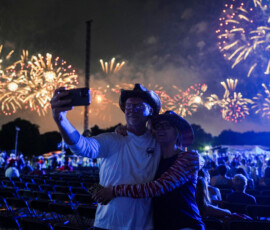 People use their phone as they attend a firework display during the Freedom 250's Salute to America as the United States celebrates its 250th anniversary on Independence Day, attempting the largest firework display in history with 850,000 fireworks in Washington, D.C., U.S., July 5, 2026. REUTERS/Nathan Howard