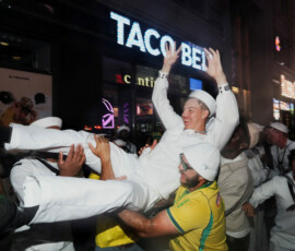 U.S. Navy personnel and Brazilian football fans throw a U.S. Navy sailor into the air outside a Taco Bell restaurant, as the United States celebrates its 250th anniversary on Independence Day, in Times Square in the Manhattan borough of New York, U.S., July 5, 2026. REUTERS/Bing Guan