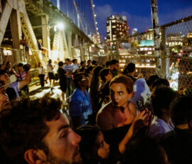 People watch as fireworks explode over the Brooklyn Bridge as the United States celebrates its 250th anniversary on Independence Day in New York City, U.S., July 4, 2026. REUTERS/Angelina Katsanis