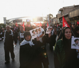 People hold signs featuring pictures of late Supreme Leader Ayatollah Ali Khamenei, who was killed on February 28 in Israeli and U.S. airstrikes, late leader of the Islamic Revolution Ayatollah Ruhollah Khomeini, and Iran's Supreme Leader Mojtaba Khamenei, on the day of a funeral procession for Khamenei in Tehran, Iran, July 6, 2026. Majid Asgaripour/WANA (West Asia News Agency) via REUTERS